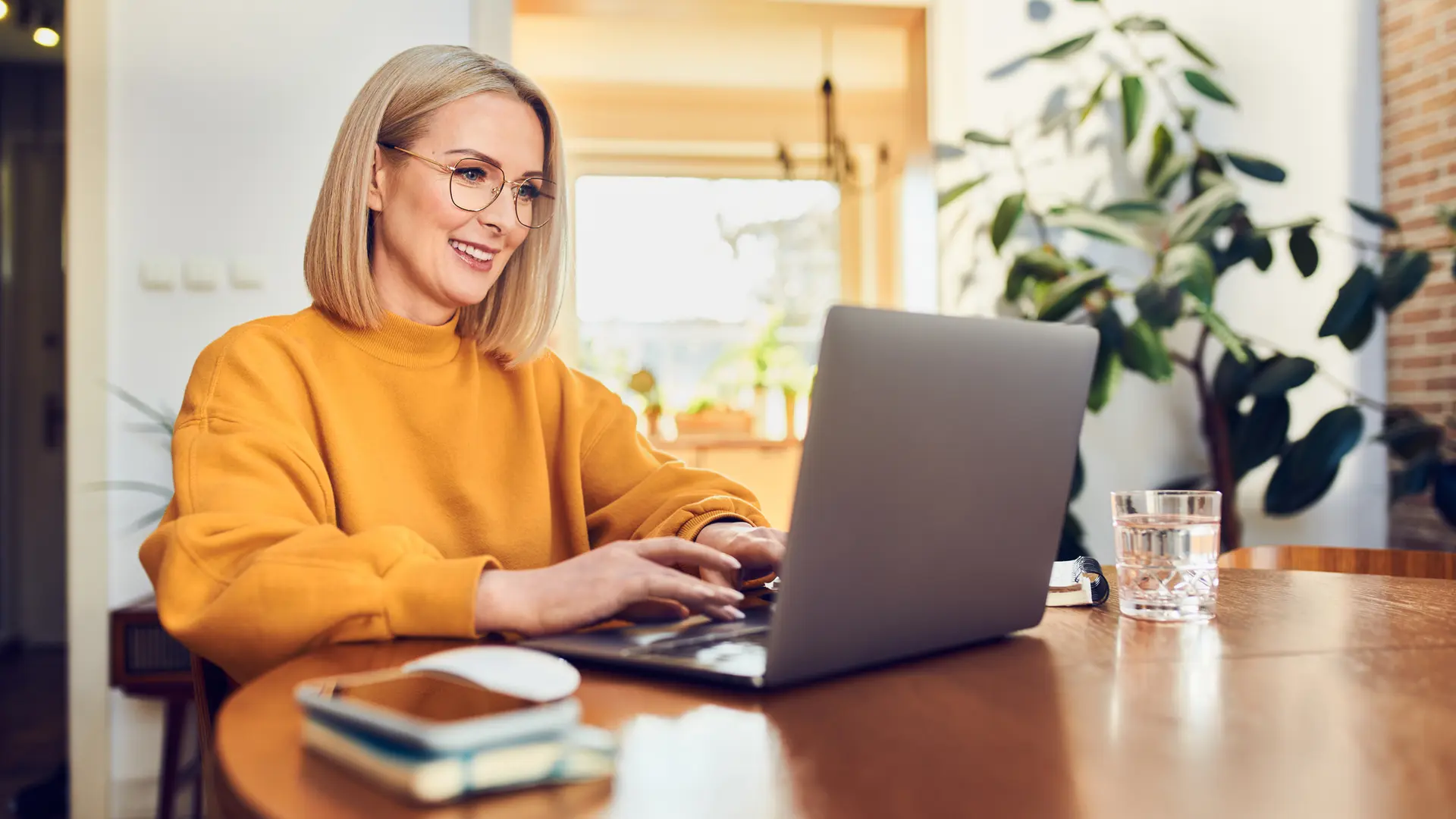 Blonde woman typing on computer